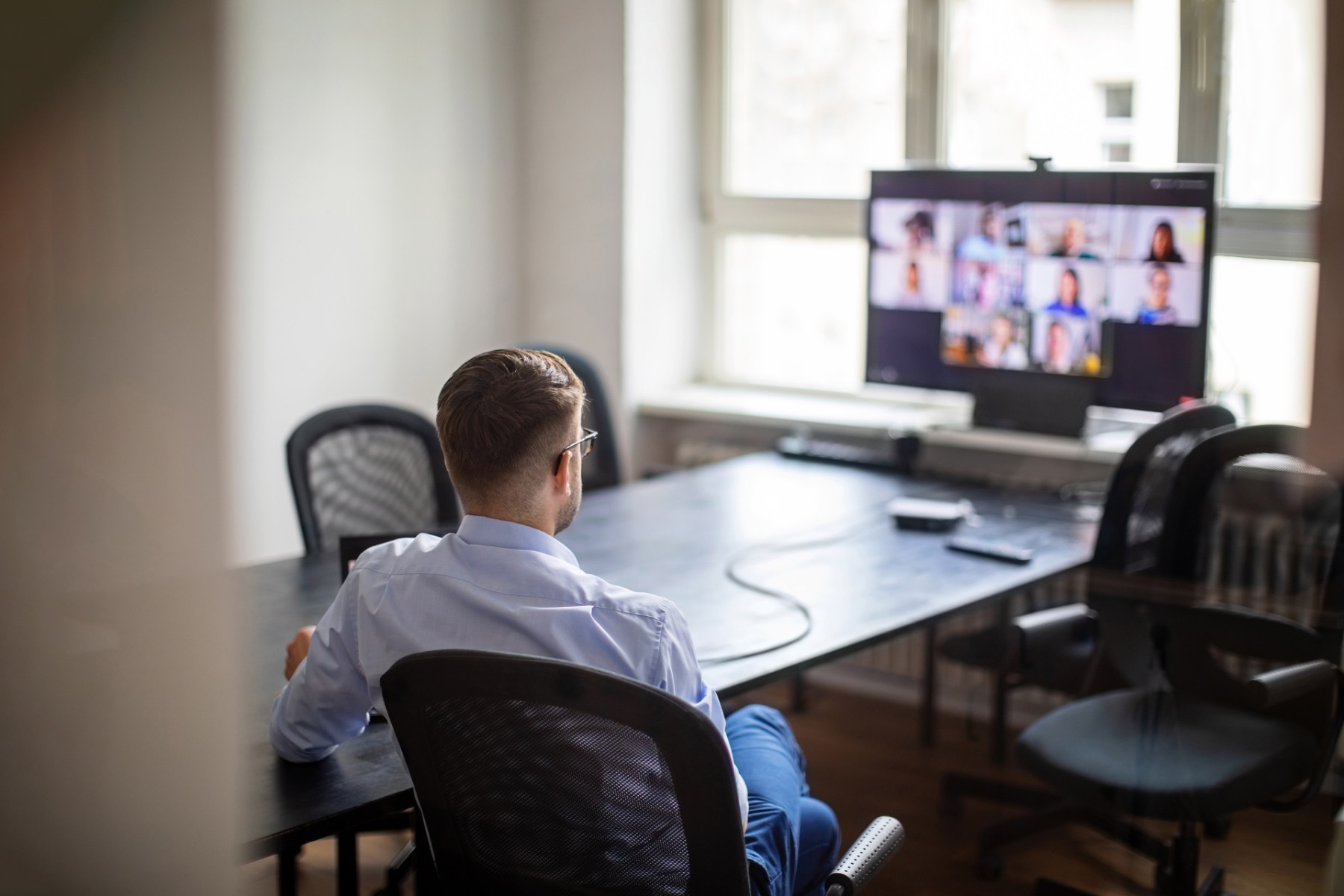 Businessman having a meeting with his team over a video call